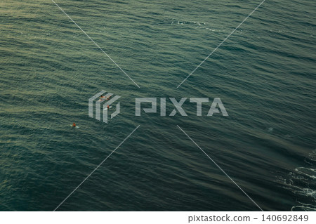 People swim in the ocean close to Bali enjoying their time People swim in the ocean close to Bali enjoying their time 140692849