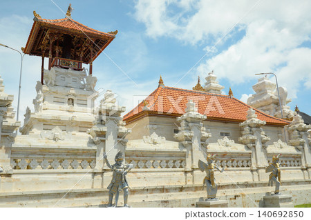 Tourists visit a temple with ornate structures in Bali Tourists visit a temple with ornate structures in Bali 140692850