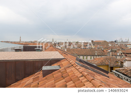 Venice, Italy - August 22, 2019: View of Venice from the roof of a house. Venice, Italy - August 22, 2019: View of Venice from the roof of a house. 140693024