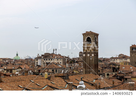 Venice, Italy - August 22, 2019: View of Venice from the roof of a house. Venice, Italy - August 22, 2019: View of Venice from the roof of a house. 140693025