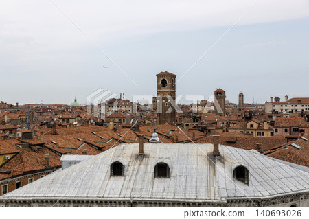 Venice, Italy - August 22, 2019: View of Venice from the roof of a house. Venice, Italy - August 22, 2019: View of Venice from the roof of a house. 140693026