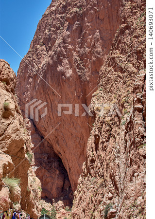 Large reddish limestone formations create a narrow natural canyon in the Todra Gorge. Large reddish limestone formations create a narrow natural canyon in the Todra Gorge. 140693071