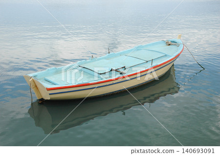 Traditional Greek Wooden Boat Floating on Calm Sea Traditional Greek Wooden Boat Floating on Calm Sea 140693091