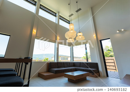 Interior view of a modern living room with a high ceiling. Interior view of a modern living room with a high ceiling. 140693182