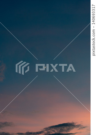 一彎新月漂浮在夜幕降臨的天空中 一彎新月漂浮在夜幕降臨的天空中 140693317