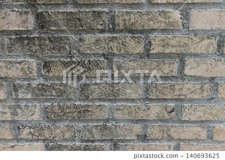 Background photo of a weathered brick exterior wall in beige and gray. Background photo of a weathered brick exterior wall in beige and gray. 140693625