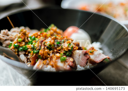 A bowl of congee or porridge with boiled rice A bowl of congee or porridge with boiled rice 140695173