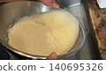 Washing rice with water 140695326