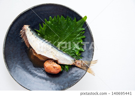 Sardines simmered in simmered plum sauce, served on a plate. 140695441