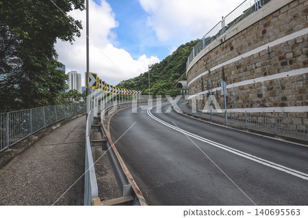 June 20 2026 HK Curving Mountain Road With Warning Signs June 20 2026 HK Curving Mountain Road With Warning Signs 140695563
