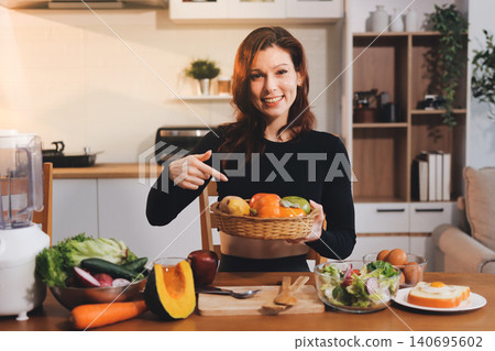 Woman preparing green smoothie in bright kitchen with fresh fruits and vegetables, healthy eating lifestyle moment in natural daylight Woman preparing green smoothie in bright kitchen with fresh fruits and vegetables, healthy eating lifestyle moment in natural daylight 140695602