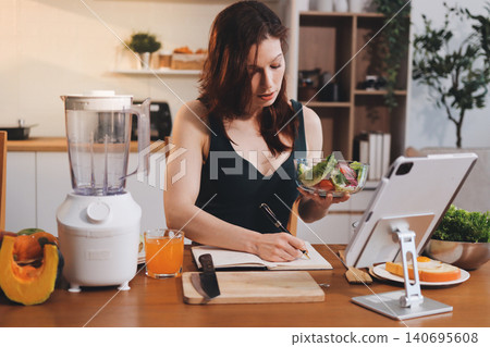 Woman preparing green smoothie in bright kitchen with fresh fruits and vegetables, healthy eating lifestyle moment in natural daylight Woman preparing green smoothie in bright kitchen with fresh fruits and vegetables, healthy eating lifestyle moment in natural daylight 140695608