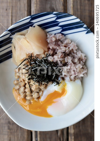 Natto rice with sixteen grains, topped with a soft-boiled egg and pickled young ginger. Natto rice with sixteen grains, topped with a soft-boiled egg and pickled young ginger. 140695725
