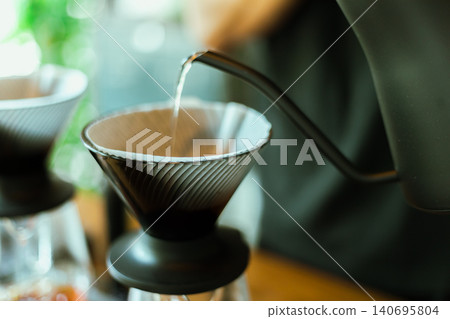 Barista making drip coffee. Barista making drip coffee. 140695804