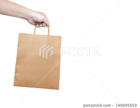 A man is holding an empty, medium-sized kraft paper bag. A man is holding an empty, medium-sized kraft paper bag. 140695859