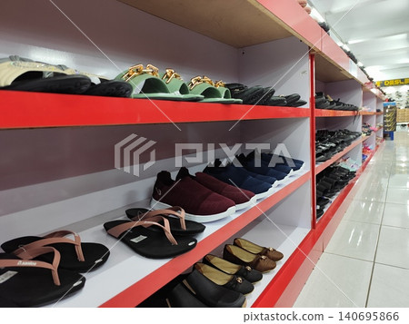 Women's shoes and sandals neatly arranged on shelves, photo taken in a supermarket Women's shoes and sandals neatly arranged on shelves, photo taken in a supermarket 140695866