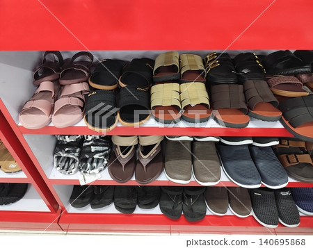Women's shoes and sandals neatly arranged on shelves, photo taken in a supermarket Women's shoes and sandals neatly arranged on shelves, photo taken in a supermarket 140695868