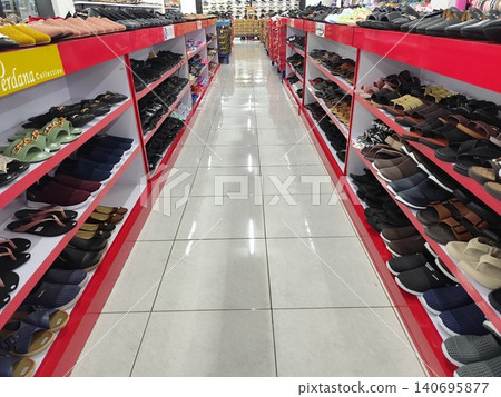 Women's shoes and sandals neatly arranged on shelves, photo taken in a supermarket Women's shoes and sandals neatly arranged on shelves, photo taken in a supermarket 140695877