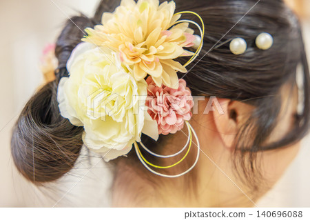 A woman in a kimono with a beautiful updo and a gorgeous floral hair ornament (viewed from behind). A woman in a kimono with a beautiful updo and a gorgeous floral hair ornament (viewed from behind). 140696088