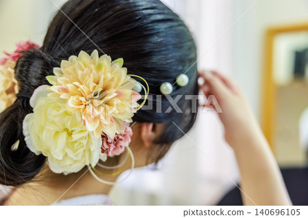 A woman in a kimono with a beautiful updo and a gorgeous floral hair ornament (viewed from behind). A woman in a kimono with a beautiful updo and a gorgeous floral hair ornament (viewed from behind). 140696105