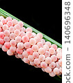close up photo of snail eggs stuck to rice leaves 140696348