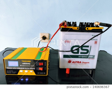 car battery being charged on the table in yogyakarta March 09,2025 car battery being charged on the table in yogyakarta March 09,2025 140696367