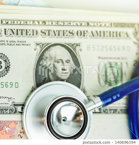 Medical stethoscope lying on a one dollar US bill background Medical stethoscope lying on a one dollar US bill background 140696394
