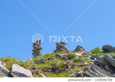 stone cairns stacked in balance against clear blue sky background stone cairns stacked in balance against clear blue sky background 140696769