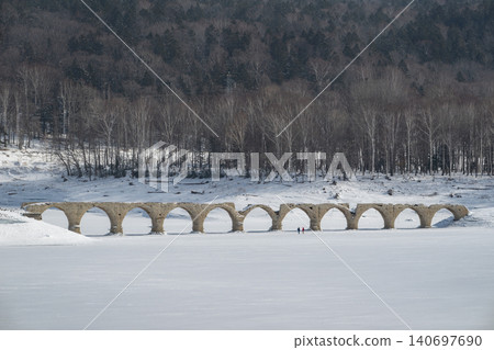 The Taushubetsu River Bridge stands in a snow-covered field during winter. The Taushubetsu River Bridge stands in a snow-covered field during winter. 140697690