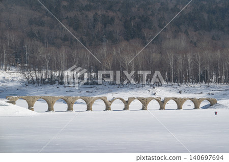 The Taushubetsu River Bridge stands in a snow-covered field during winter. The Taushubetsu River Bridge stands in a snow-covered field during winter. 140697694