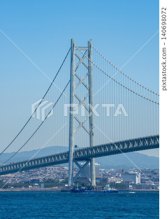 The main towers of the Akashi Kaikyo Bridge, soaring over the sea. The main towers of the Akashi Kaikyo Bridge, soaring over the sea. 140698072