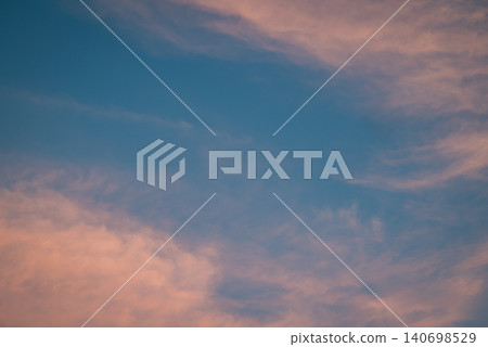 Light clouds illuminated by last sun rays in the sky. Calm evening, bright clouds high up in sky Light clouds illuminated by last sun rays in the sky. Calm evening, bright clouds high up in sky 140698529
