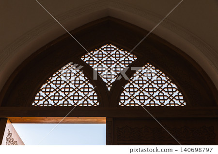 An ornate Islamic lattice window with geometric mashrabiya pattern. Tashkent An ornate Islamic lattice window with geometric mashrabiya pattern. Tashkent 140698797