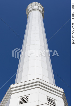 White minaret of the Minor Mosque is under blue sky on a sunny day. Tashkent White minaret of the Minor Mosque is under blue sky on a sunny day. Tashkent 140698800