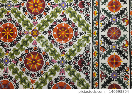 Colorful embroidered Suzani textile featuring traditional floral motifs Colorful embroidered Suzani textile featuring traditional floral motifs 140698804