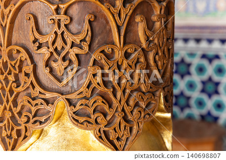 Ornate hand-carved wood pillar with leaf accent Ornate hand-carved wood pillar with leaf accent 140698807