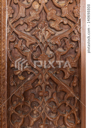 Ornate carved wooden panel featuring floral arabesque patterns Ornate carved wooden panel featuring floral arabesque patterns 140698808