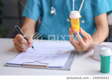 Doctor or authorized medical professional orders a specific medication for a patient to treat an illness or injury. Doctor or authorized medical professional orders a specific medication for a patient to treat an illness or injury. 140698881