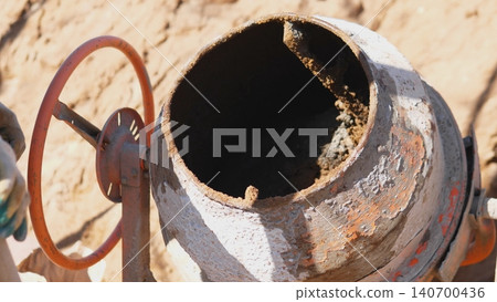 Operator Inspecting Concrete Mixer Drum Interior For Residue And Corrosion, Hands Near Rim With Glove, Tools And Brush Ready For Cleaning And Maintenance, Routine Site Service Captured Operator Inspecting Concrete Mixer Drum Interior For Residue And Corrosion, Hands Near Rim With Glove, Tools And Brush Ready For Cleaning And Maintenance, Routine Site Service Captured 140700436
