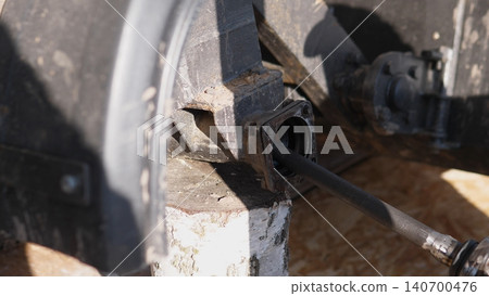 Mechanic Examines Axle Bearing Carefully. Closeup Of Bearing With Grease Deposits Examined. Detailed Closeup Of Axle Bearing With Grease And Mechanic Analyzing Seal And Journal Thoroughly 140700476