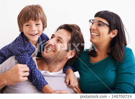 Happy family, portrait and love on sofa to relax, weekend and bonding together in living room. Parents, boy child and smile face for affection in trust, embrace and parent support on vacation in home Happy family, portrait and love on sofa to relax, weekend and bonding together in living room. Parents, boy child and smile face for affection in trust, embrace and parent support on vacation in home 140700724