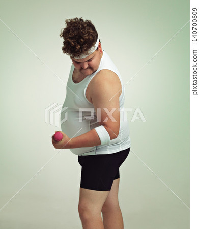 Man, bicep and dumbbell in studio for workout, plus size and exercise for weight loss on background. Male person, training and gym equipment for health, challenge and body development for fitness 140700809