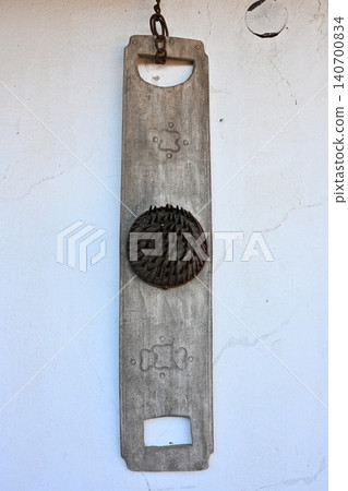 Antique Wooden Flax Comb or Carding Tool Hanging on White Wall Antique Wooden Flax Comb or Carding Tool Hanging on White Wall 140700834