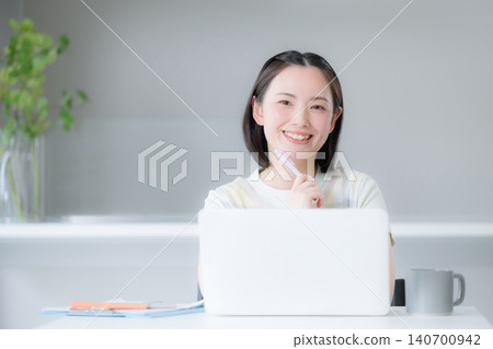A housewife considers NISA (Nippon Individual Savings Account) for wealth building, focusing on stocks and investment trusts; she smiles at the camera while discussing measures to address rising inflation for household finances and the future. A housewife considers NISA (Nippon Individual Savings Account) for wealth building, focusing on stocks and investment trusts; she smiles at the camera while discussing measures to address rising inflation for household finances and the future. 140700942