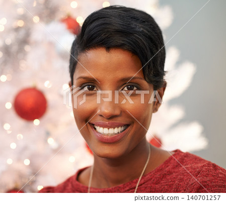 Smile, christmas and portrait of woman at her home for festive event, party or celebration. Happy, holidays and face of female person from Colombia with xmas tree on sofa in living room at apartment. Smile, christmas and portrait of woman at her home for festive event, party or celebration. Happy, holidays and face of female person from Colombia with xmas tree on sofa in living room at apartment. 140701257