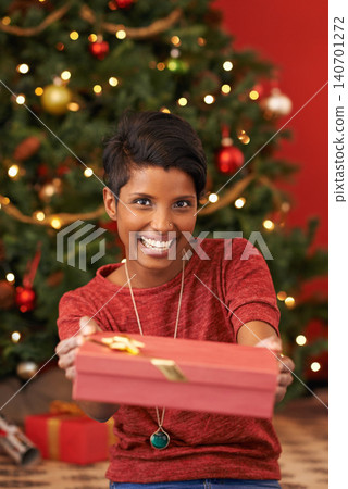Christmas, portrait and woman with gift giving for celebration offer and kindness on festive holiday. Smile. person and face with happiness for present, share and special event in living room Christmas, portrait and woman with gift giving for celebration offer and kindness on festive holiday. Smile. person and face with happiness for present, share and special event in living room 140701272