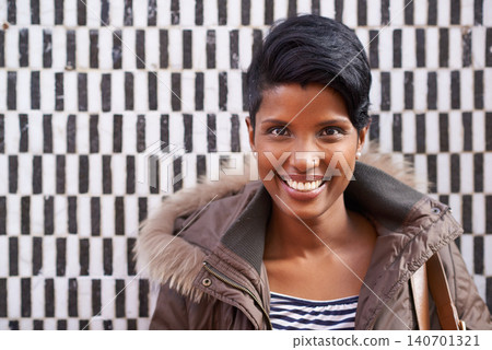 Woman, portrait and smile with jacket, happiness and urban style with optimism. Person, fashion and excited for winter, satisfaction and positive natural beauty on trendy checkered wall background Woman, portrait and smile with jacket, happiness and urban style with optimism. Person, fashion and excited for winter, satisfaction and positive natural beauty on trendy checkered wall background 140701321