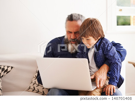 Grandfather, laptop and boy child for games, elearning and bonding in living room. Kids, family and internet for play or learning online, childhood development and streaming on technology for learn Grandfather, laptop and boy child for games, elearning and bonding in living room. Kids, family and internet for play or learning online, childhood development and streaming on technology for learn 140701408