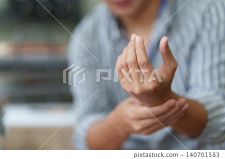 Cropped shot of man massaging wrist for carpal tunnel syndrome pain relief 140701583