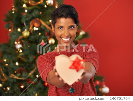 Christmas, heart and portrait of happy woman with gift in box or package at home for holiday celebration on mockup space in India. Xmas, face and giving present for love on festive season in house Christmas, heart and portrait of happy woman with gift in box or package at home for holiday celebration on mockup space in India. Xmas, face and giving present for love on festive season in house 140701794